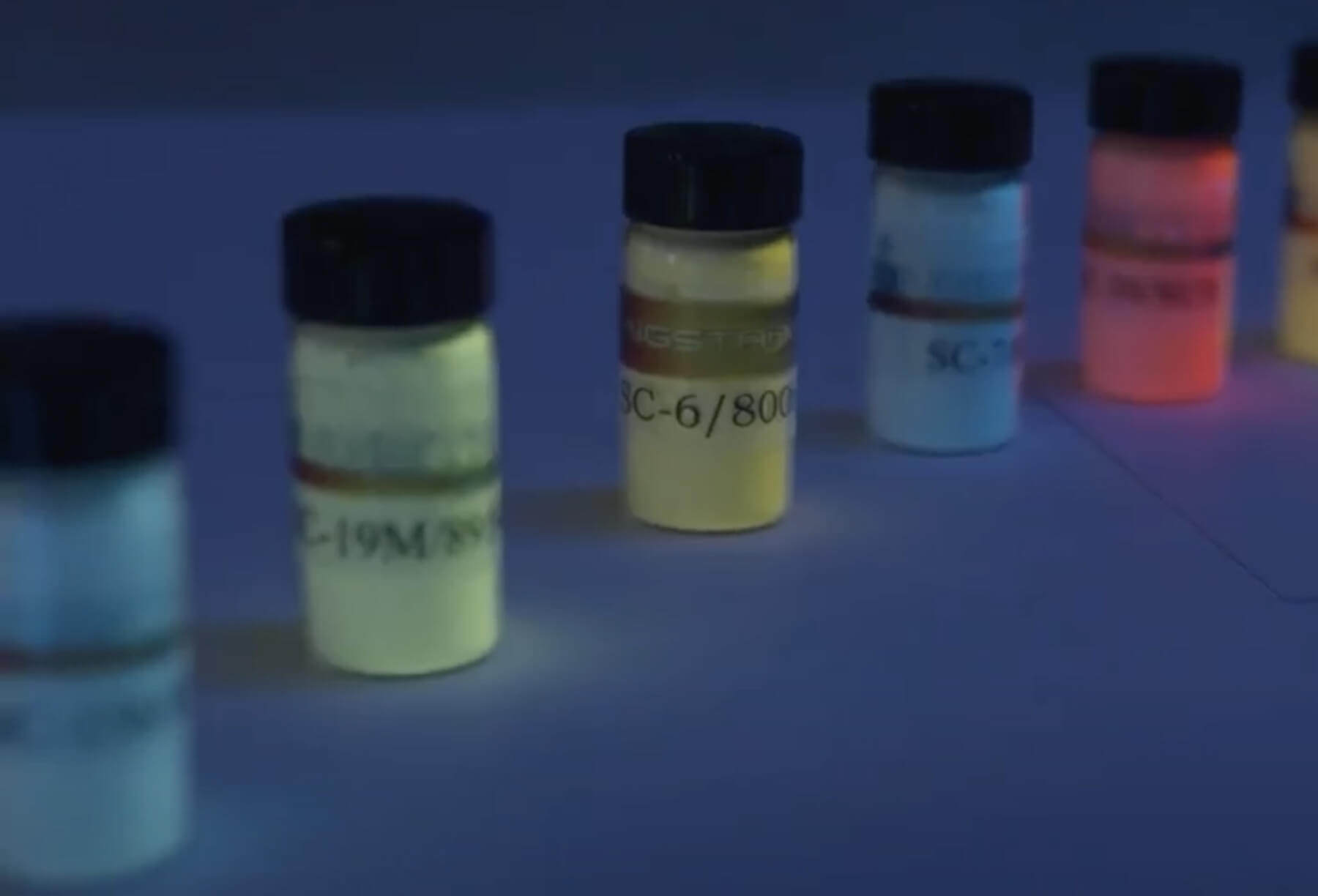 Small jars of fluorescent powders